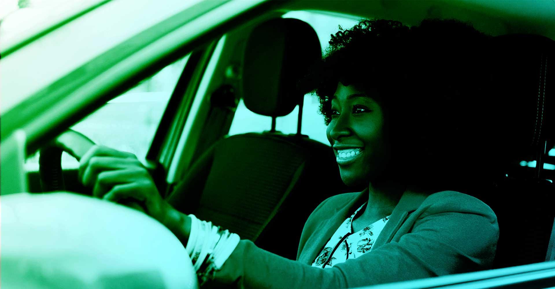 A happy person behind the wheel of their car